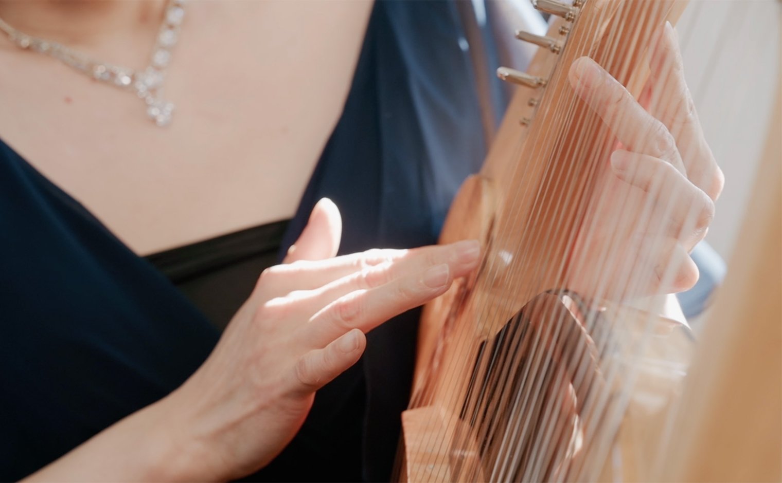 女性がライアーを演奏している写真